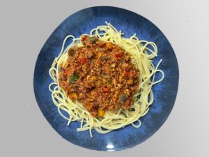 Špagety Bolognese Arrabiata servírované na modrom tanieri. Výborné jedlo bez mäsa. Je súčasťou NFI protokolu, ktorý je vytvorený na stabilizáciu až vyliečenie cukrovky u diabetikov 2. typu. Pomáha i ľuďom s nadváhou a obezitou.